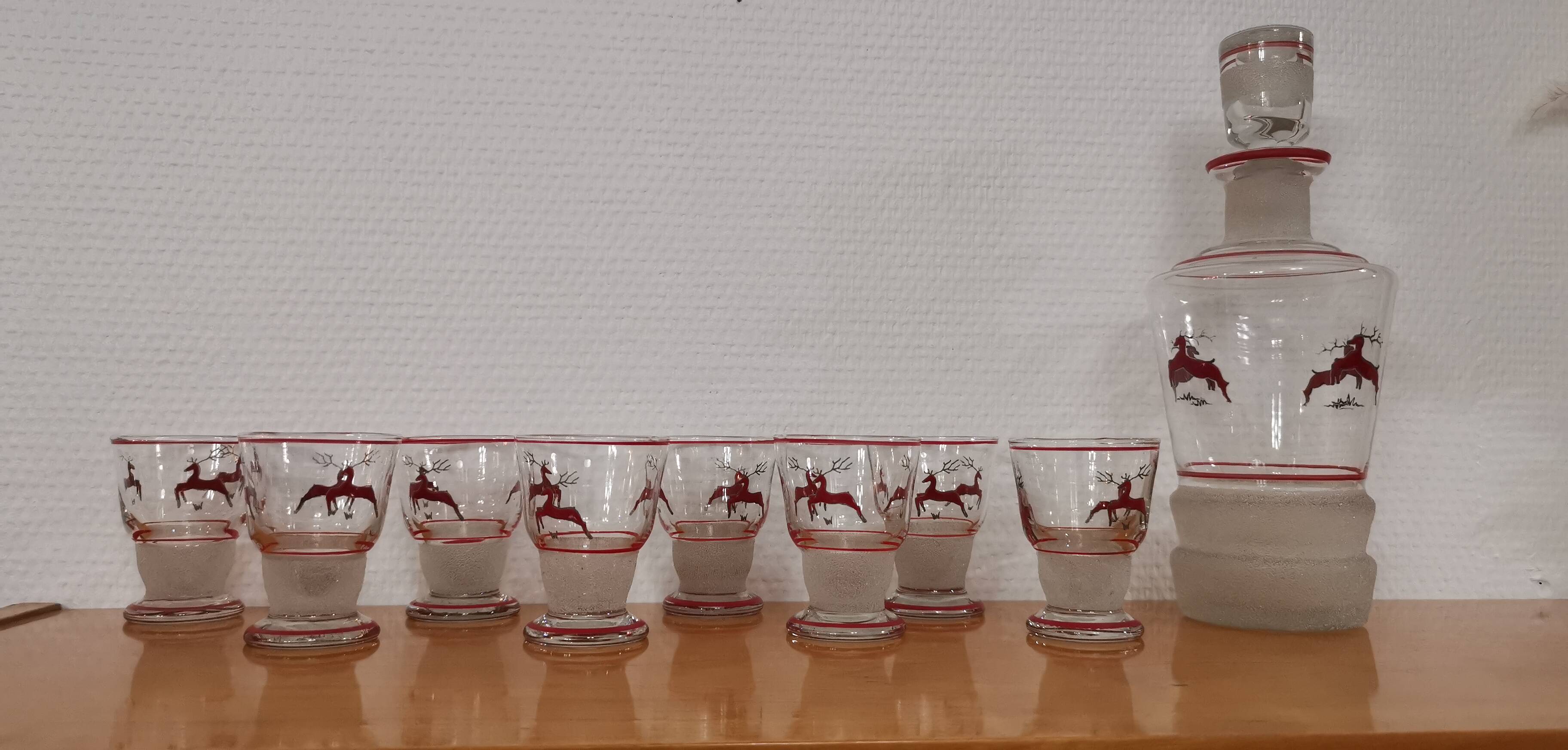 Glasses and carafe decorated with red Christmas reindeer and white granita 60's