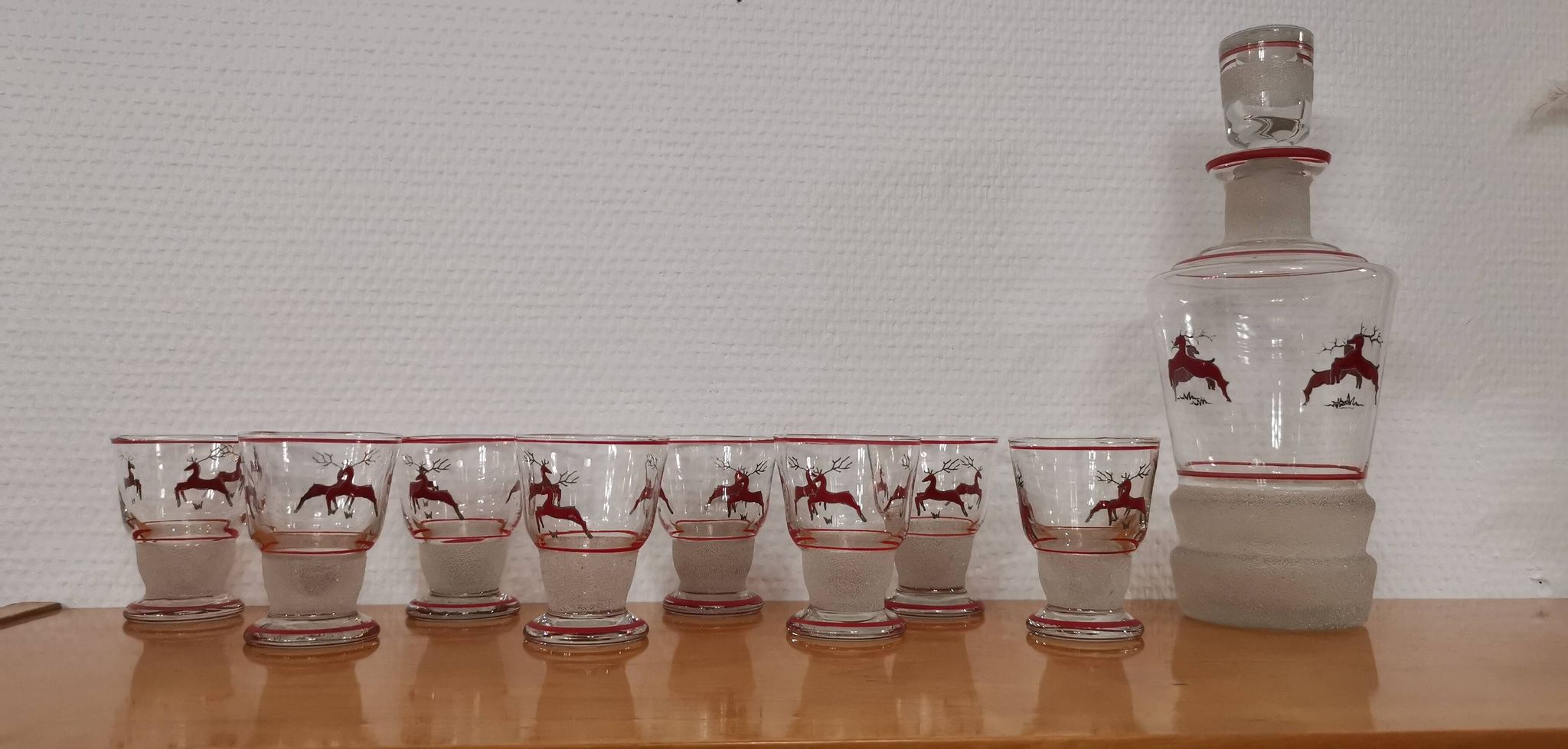 Glasses and carafe decorated with red Christmas reindeer and white granita 60's