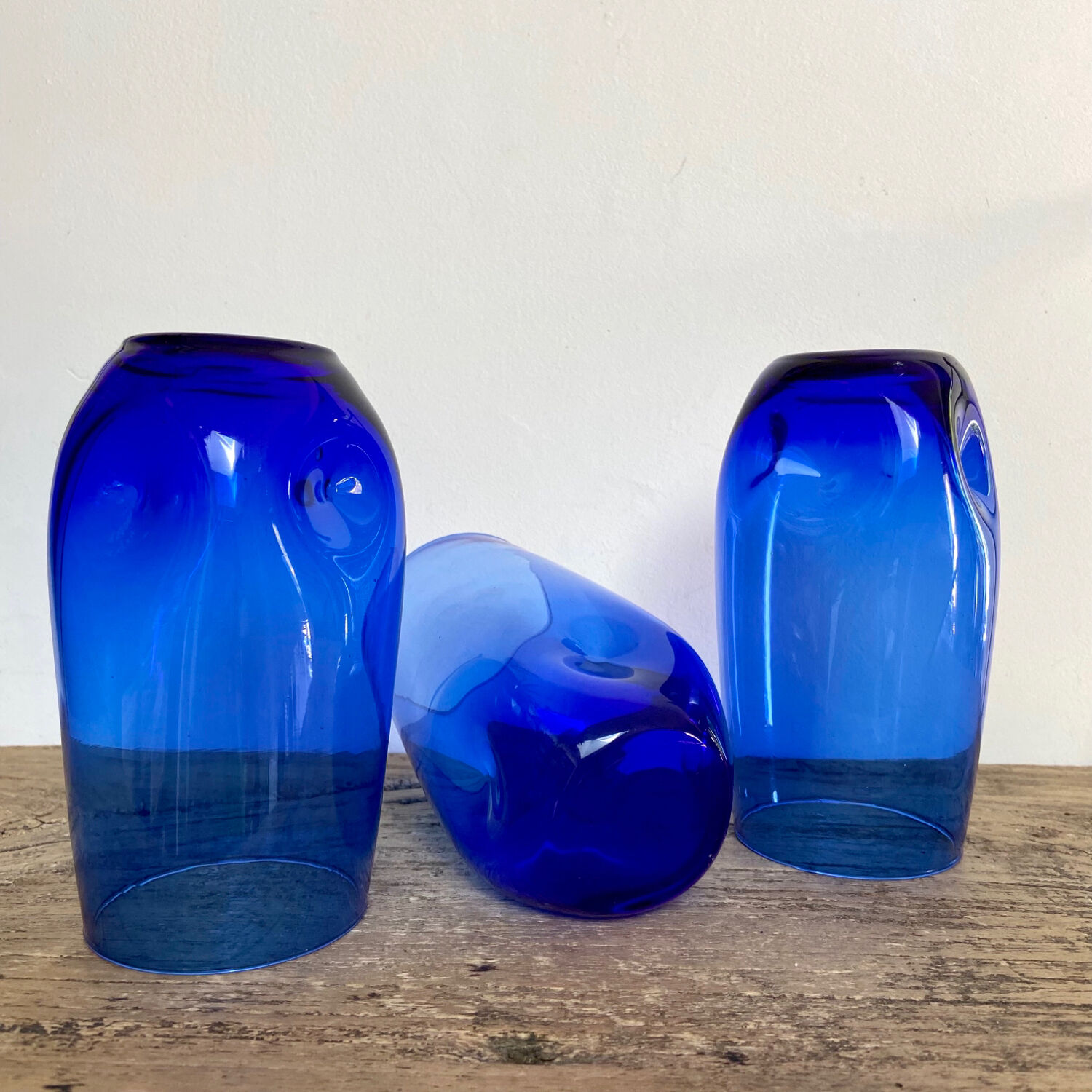 3 blue colored long drink glasses