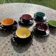 Coffee service composed of 5 cups and saucers in black earthenware and different colored interiors