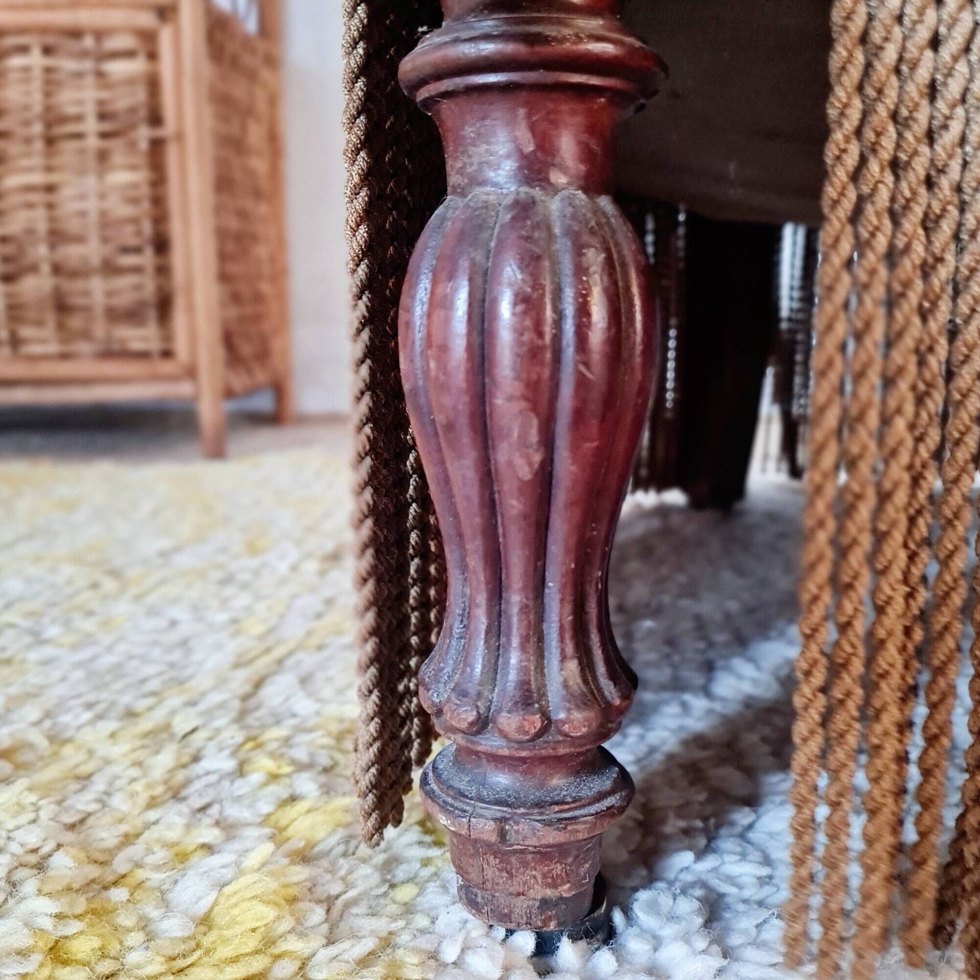 Brown velvet crapaud armchair with fringes and sculpted legs.