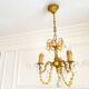 Small vintage brass chandelier with amber crystal pendants.