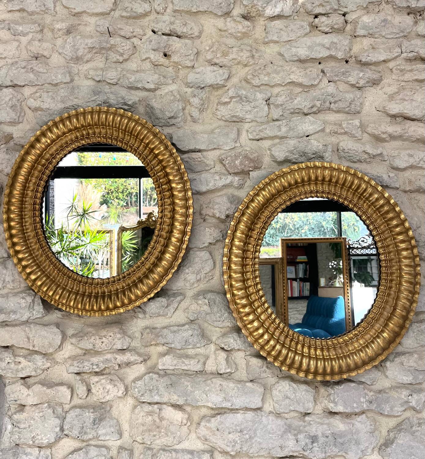 Pair of antique oval mirrors gilded with gold leaf and mercury.