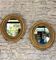 Pair of antique oval mirrors gilded with gold leaf and mercury.