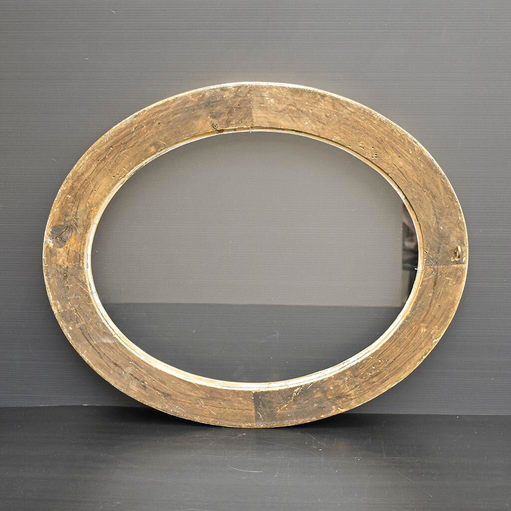 Delightful empty old gilded oval frame with carved wood and stucco flowers 63 x 53