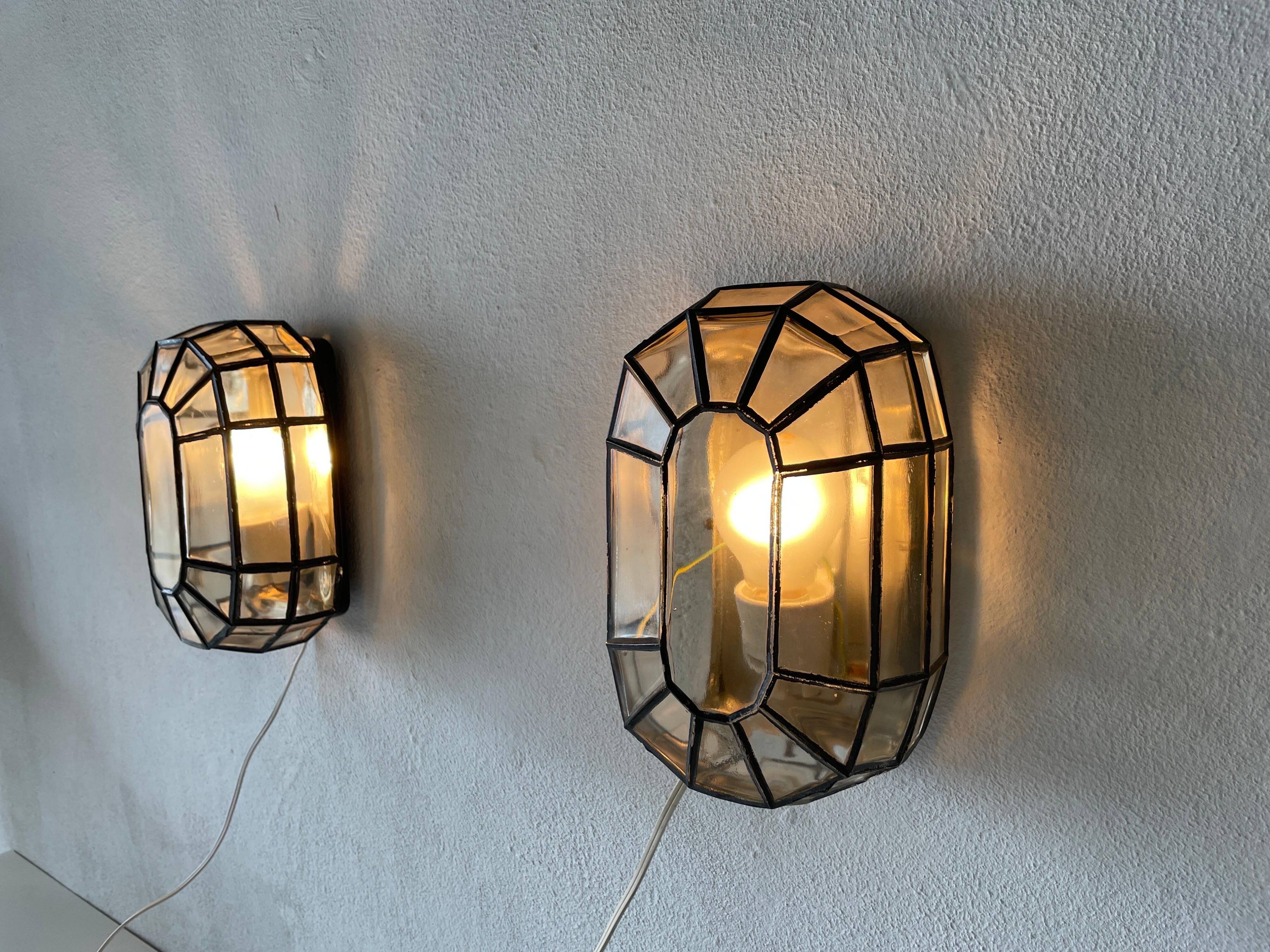 Pair of black iron wall sconces with structured glass by Limburg, 1960s, Germany.