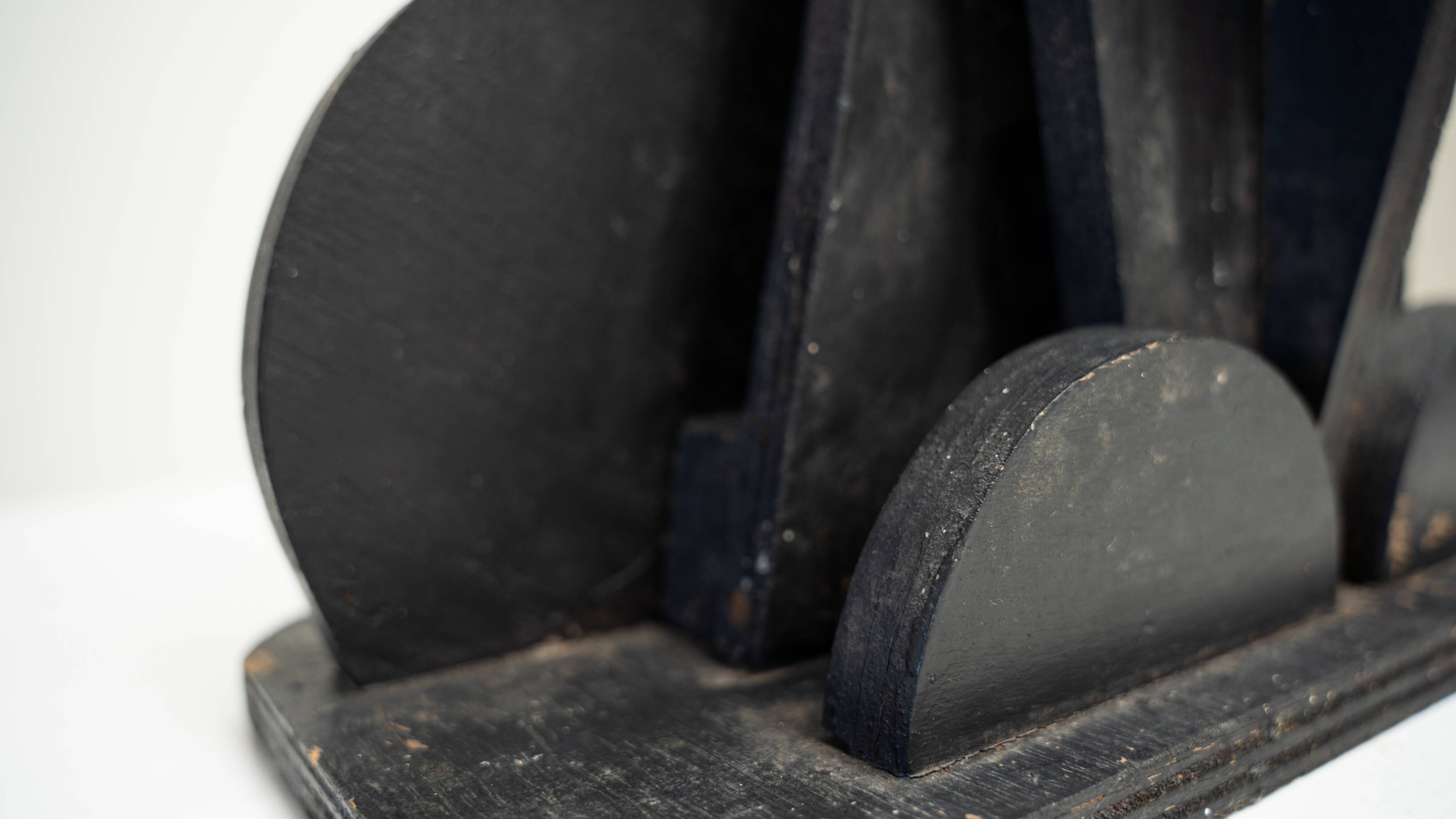 Black brutalist wooden sculpture