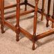 Nested tables in satin wood with brass inlays.