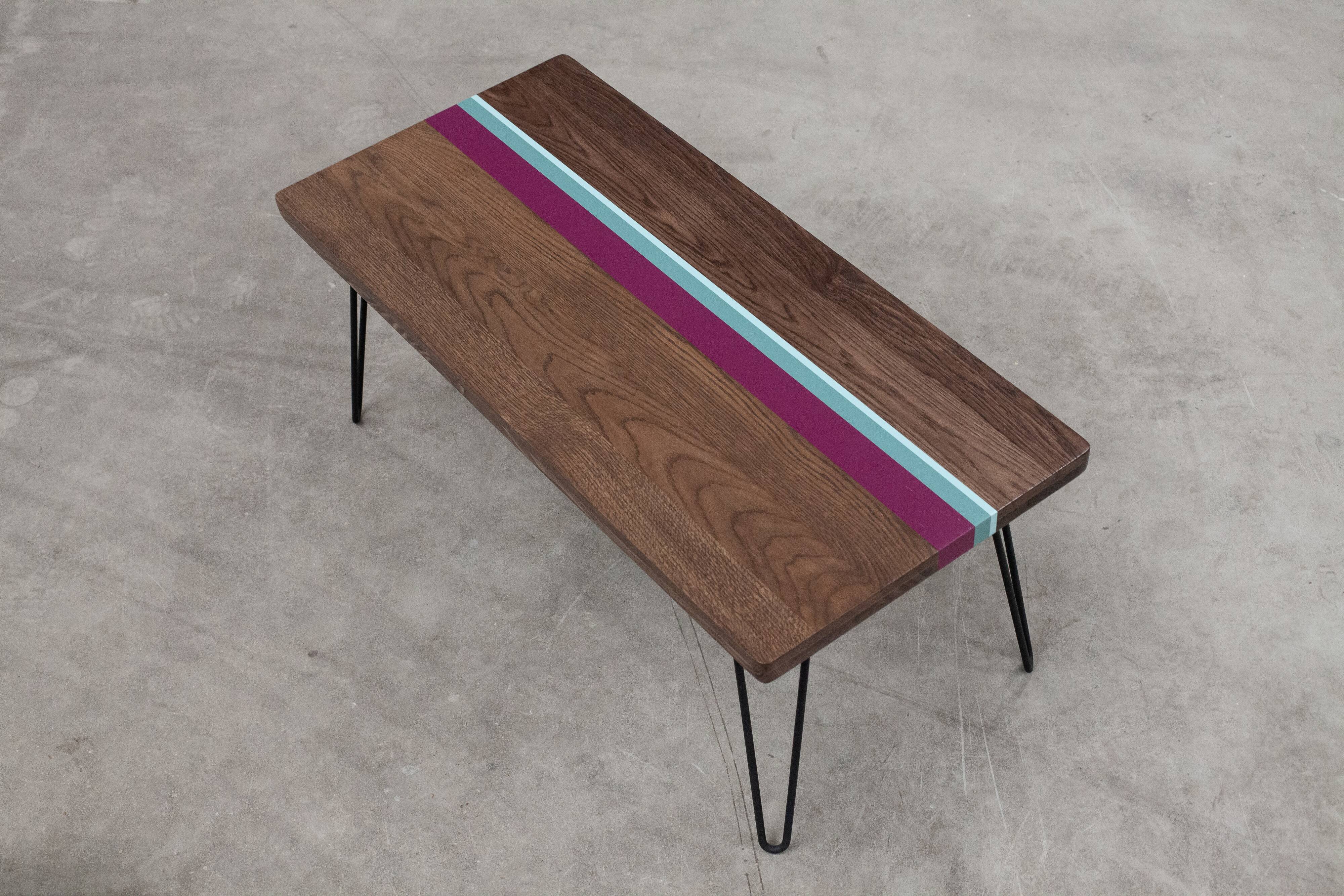 Solid oak coffee table with colored bands on pin legs