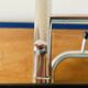 Vintage wall-mounted coat rack in wood and chrome metal with mirror