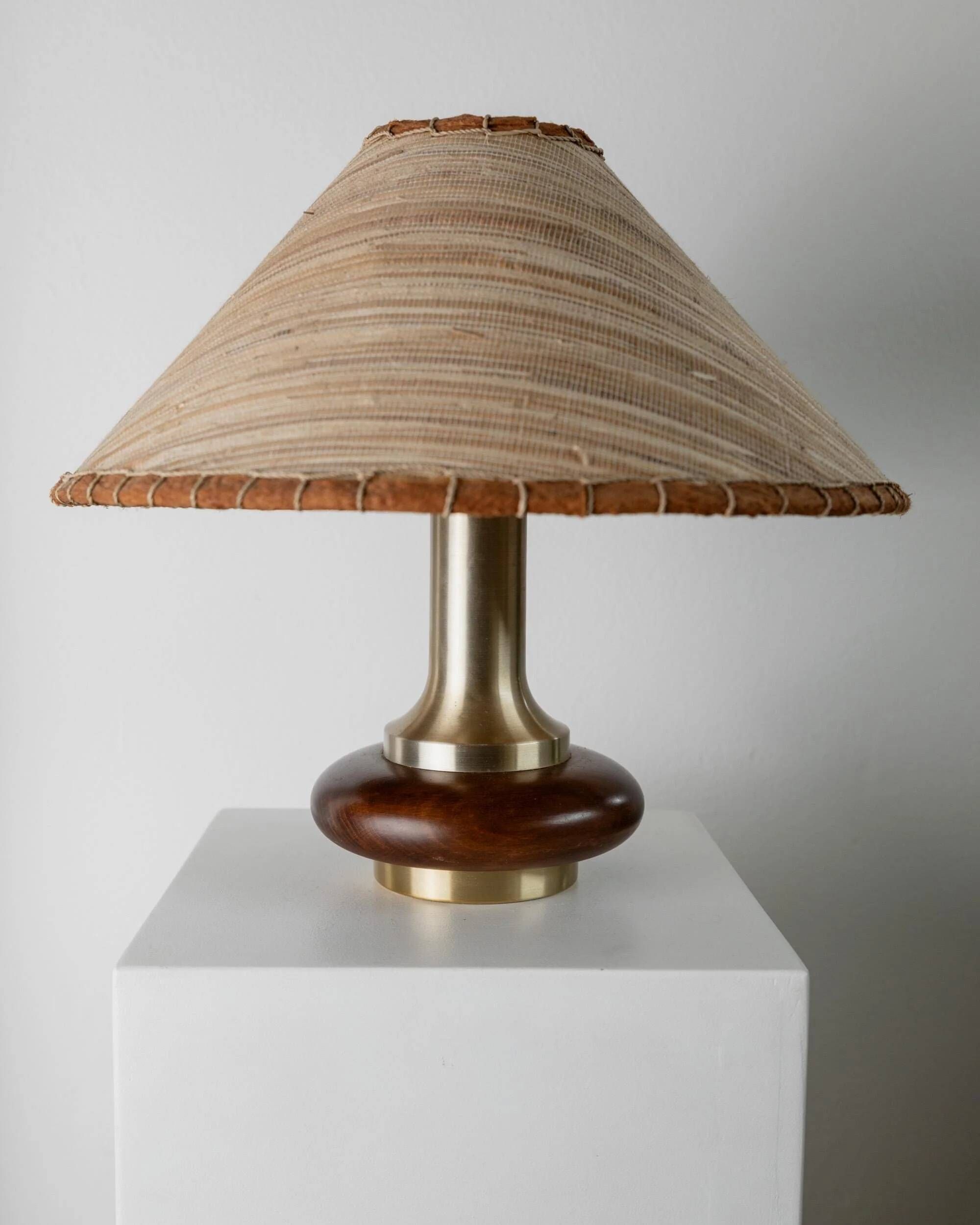 Lot of 2 vintage table lamps from the 1970s, dark wood oval bases with curved brass details, handmade natural fibre lampshades, elegant lighting.