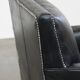 Armchair in black grained cowhide leather with a deep seat