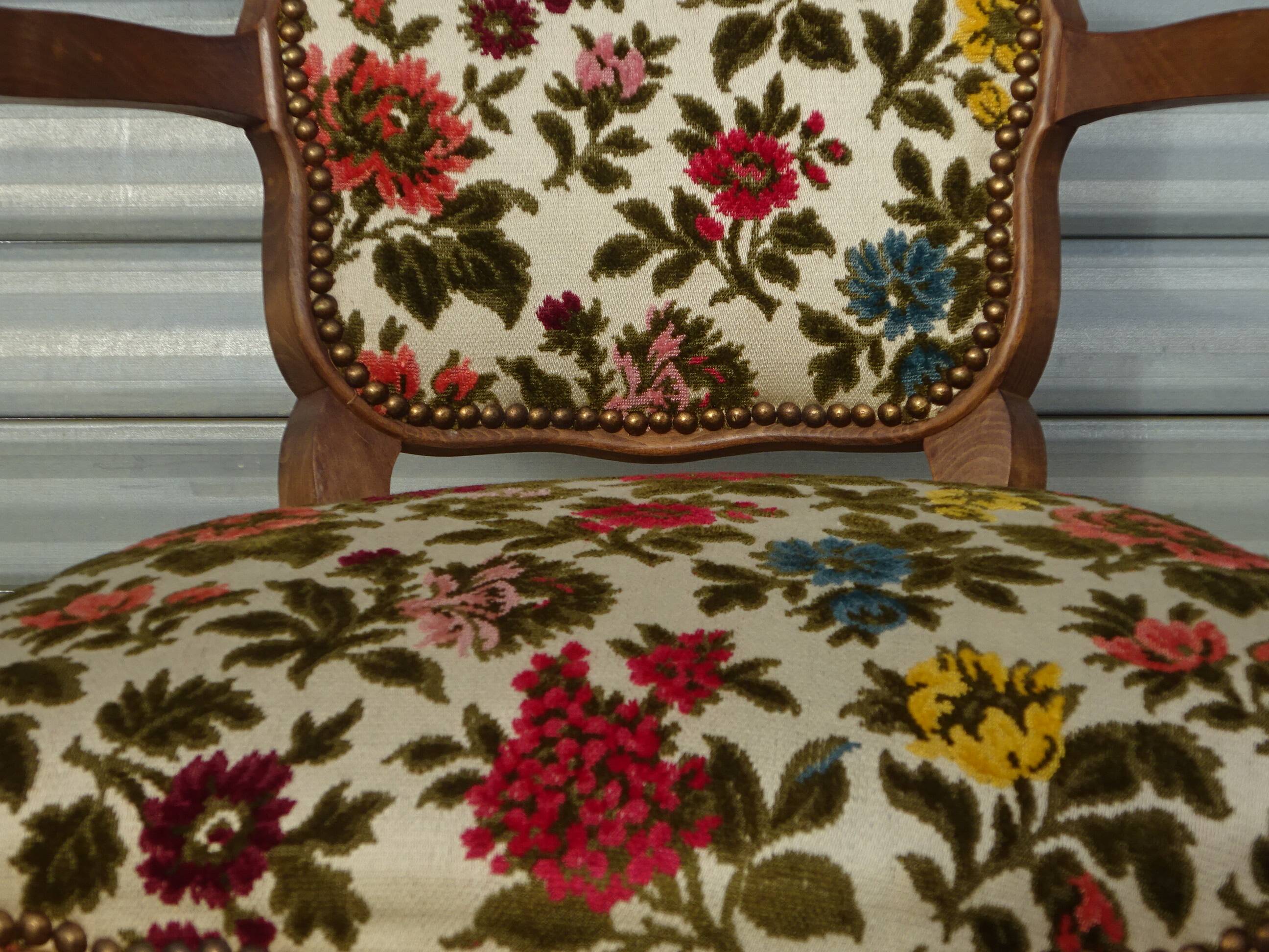 Convertible armchair with brocade fabric and floral patterns.