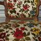Convertible armchair with brocade fabric and floral patterns.