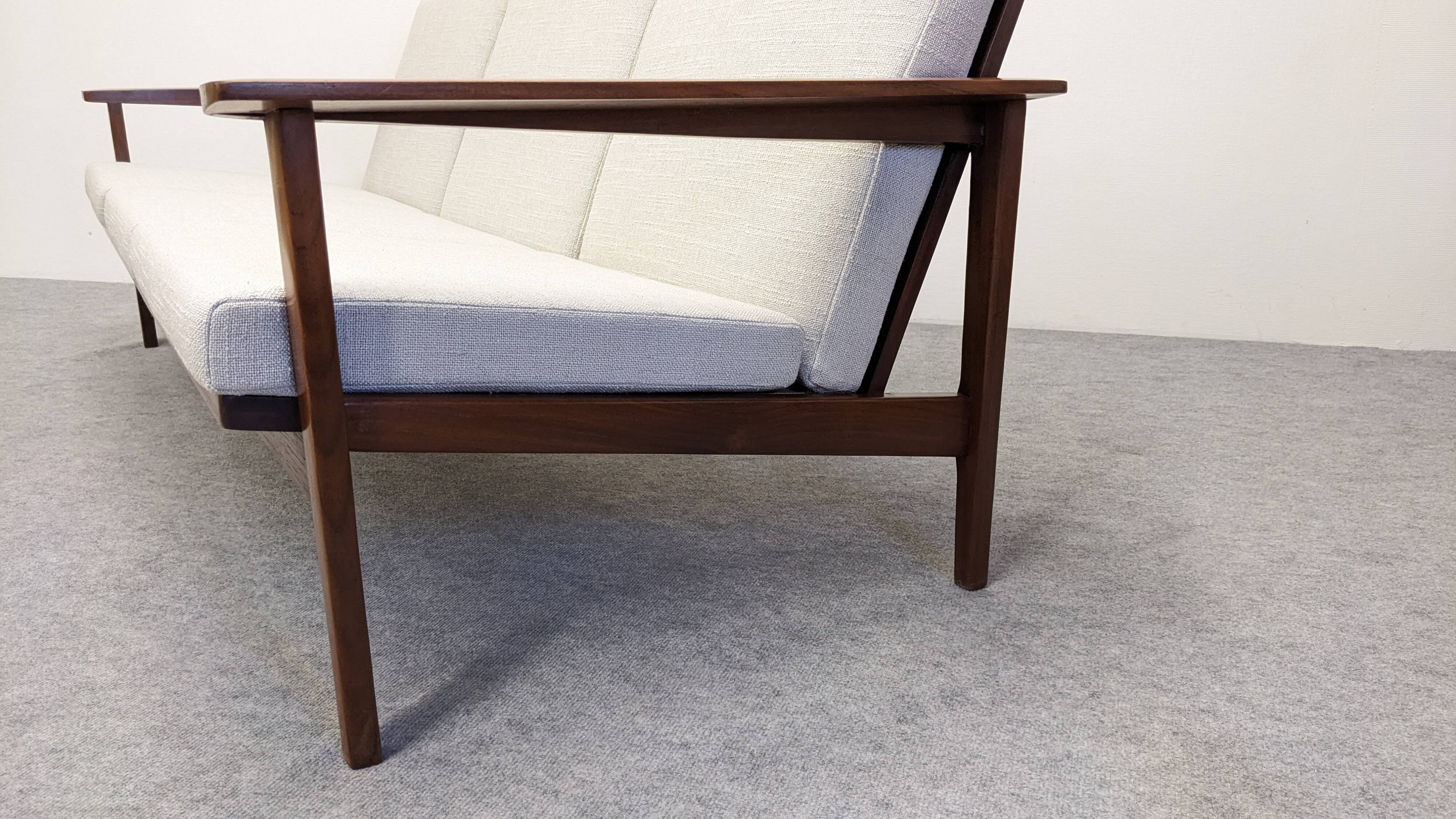 Scandinavian style three-seater sofa in teak, France circa 1950.