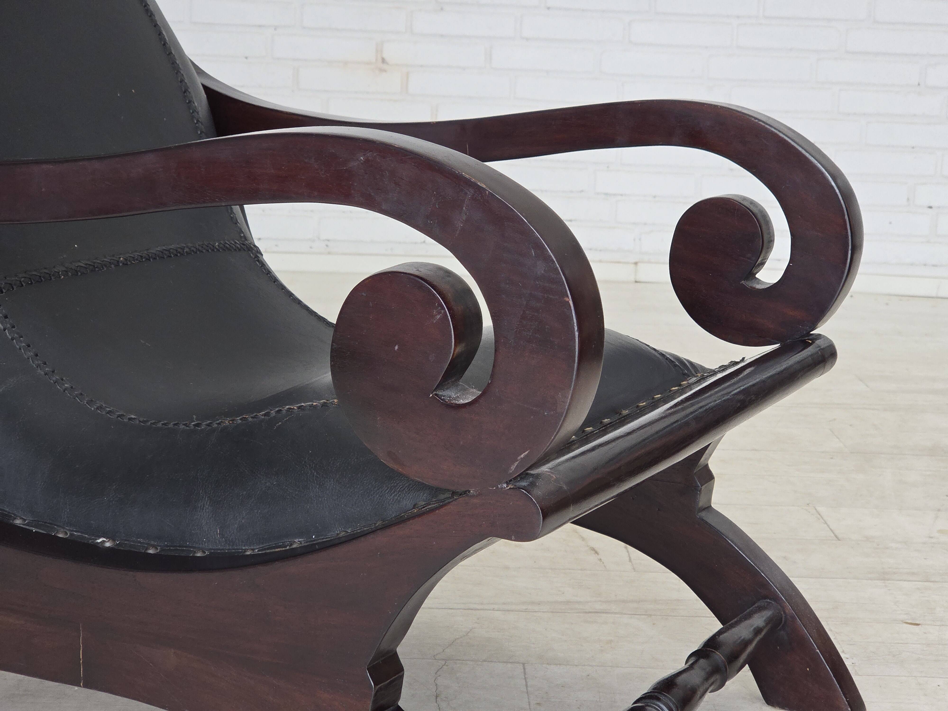 1970s, vintage armchair with footstool, black furniture leather.
