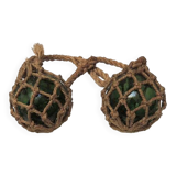 Old glass fishing float with rope net