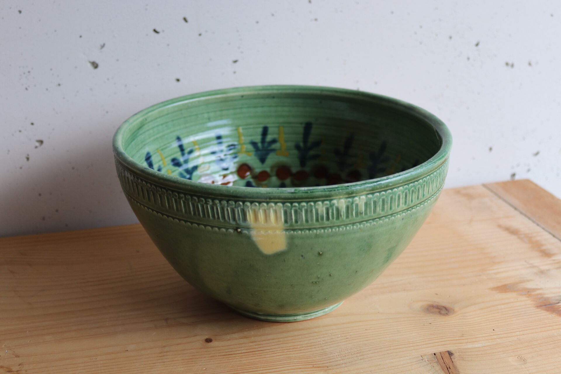 Large glazed ceramic salad bowl with a floral design.