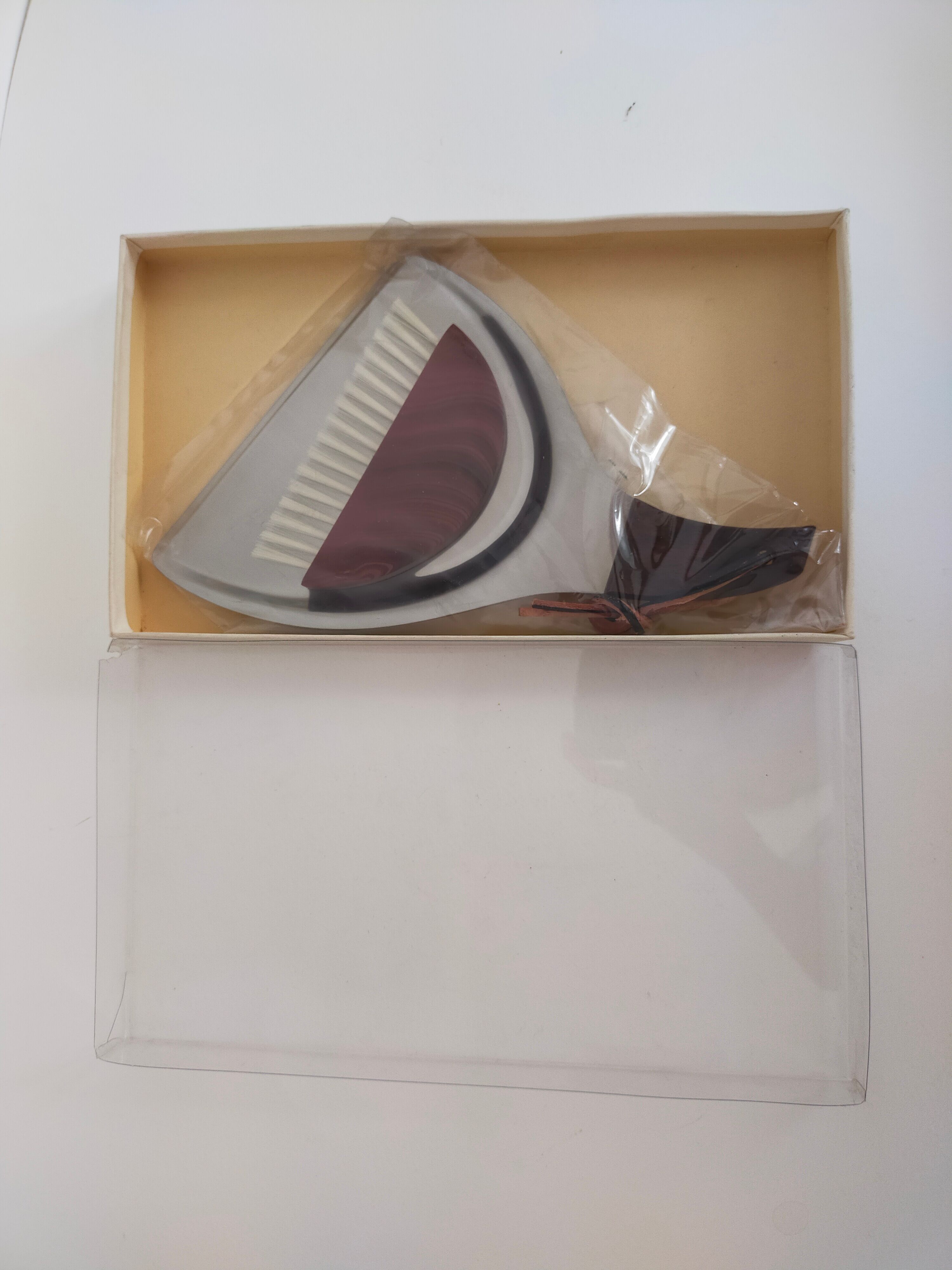 Picks up new vintage shovel and sweeper crumbs