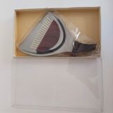 Picks up new vintage shovel and sweeper crumbs