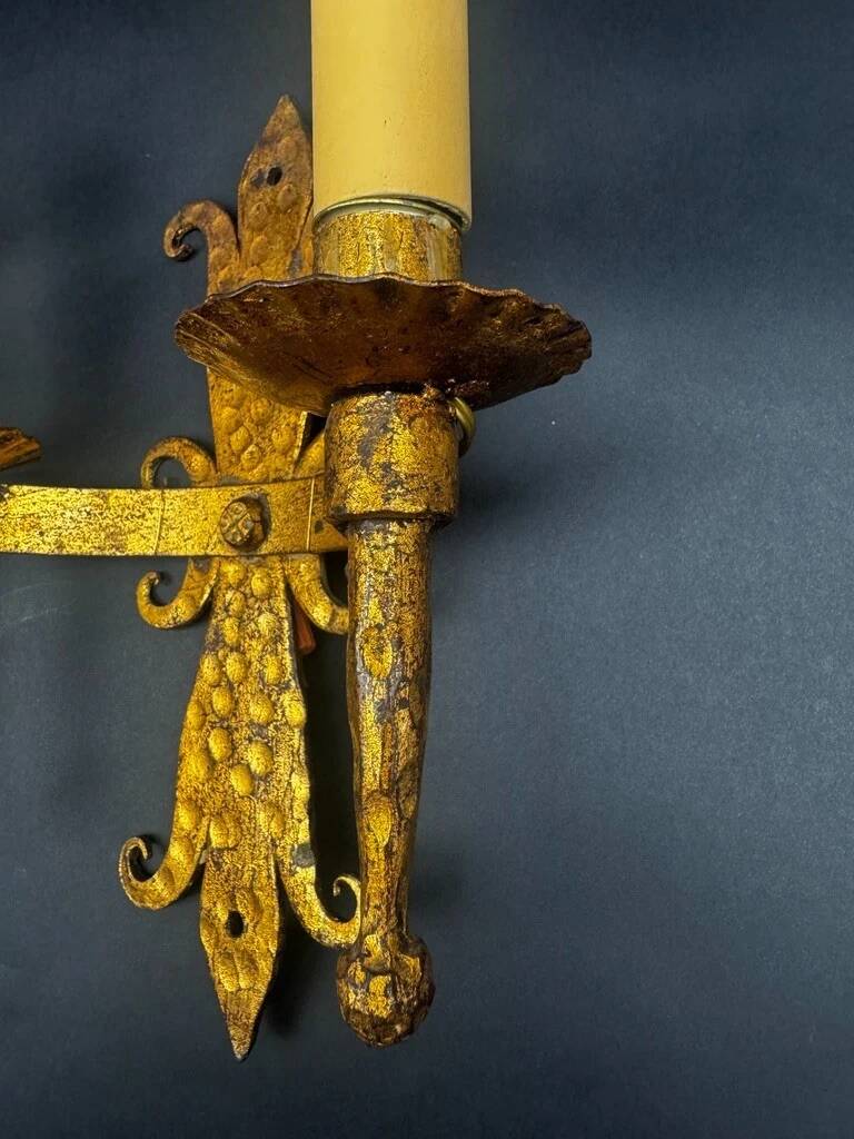 Pair of electrified golden wrought iron gothic wall sconces.