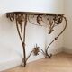 Golden wrought iron console and mirror in rococo style.