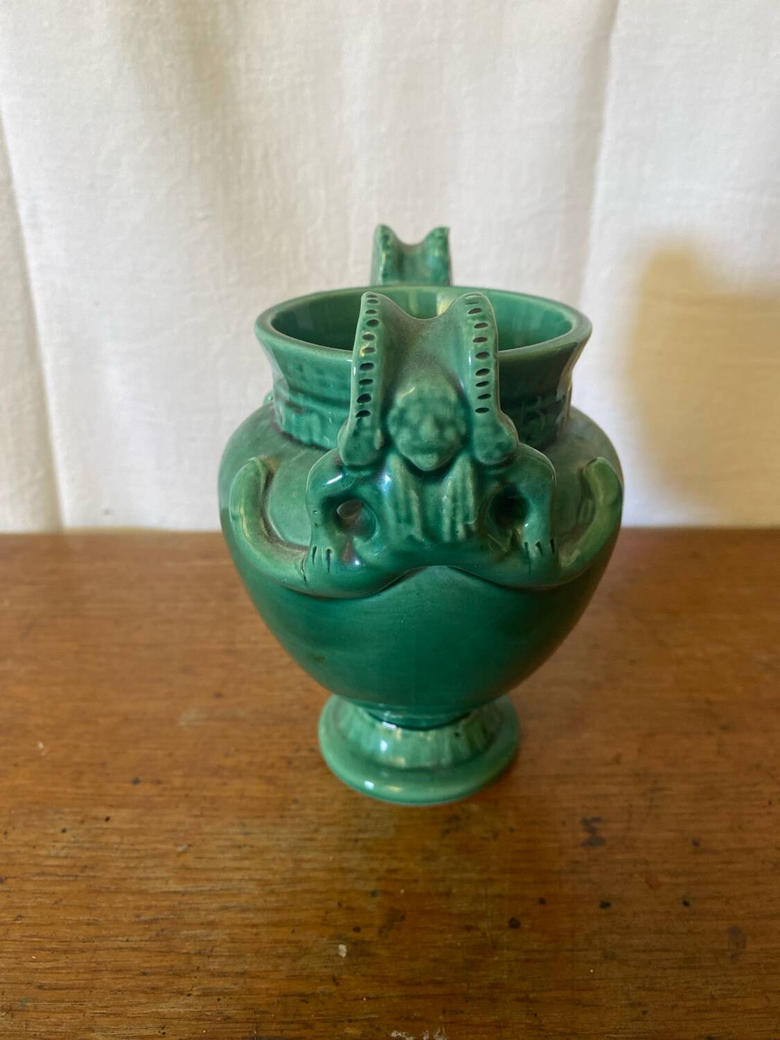 Antique green ceramic vase with handles