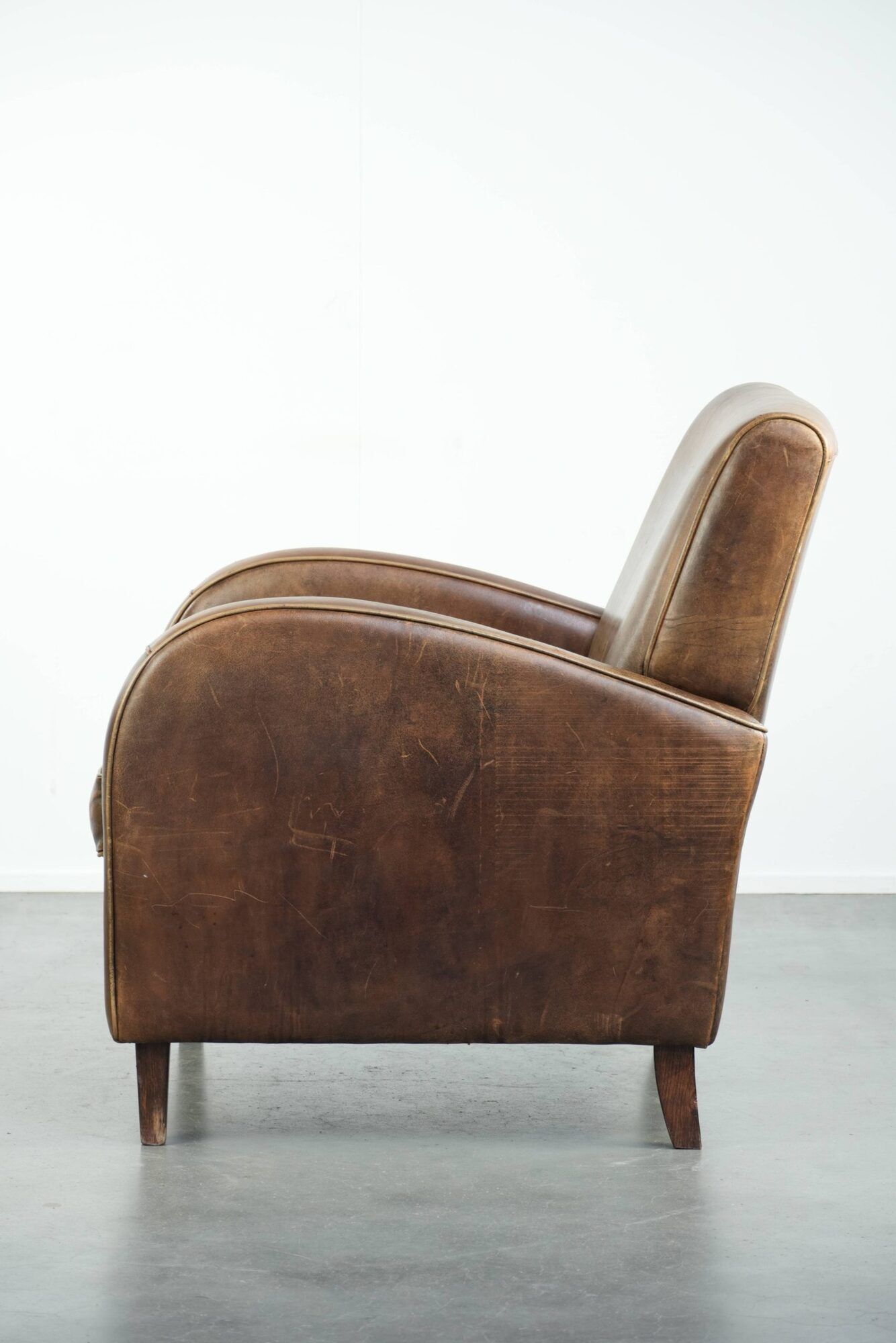 Sheepskin armchair in a light cognac colour with matching piping