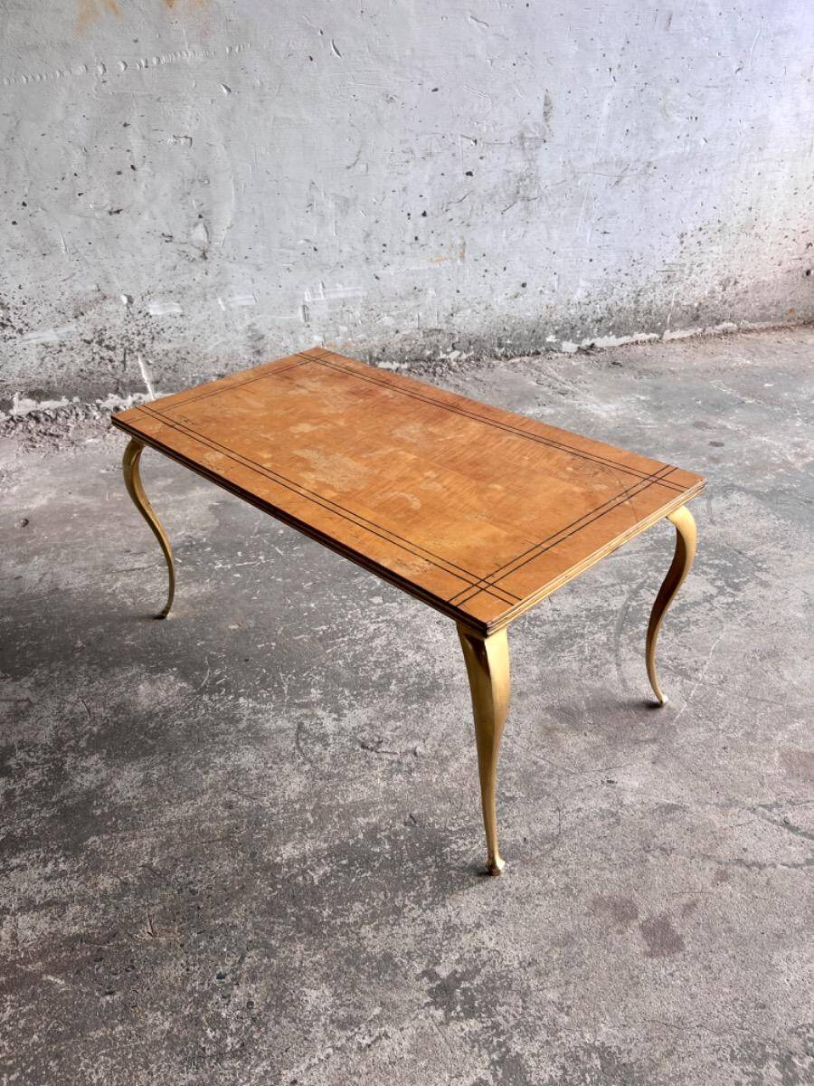 Vintage coffee table with gold-gilded legs and light brown wood veneer geometric inlaid top