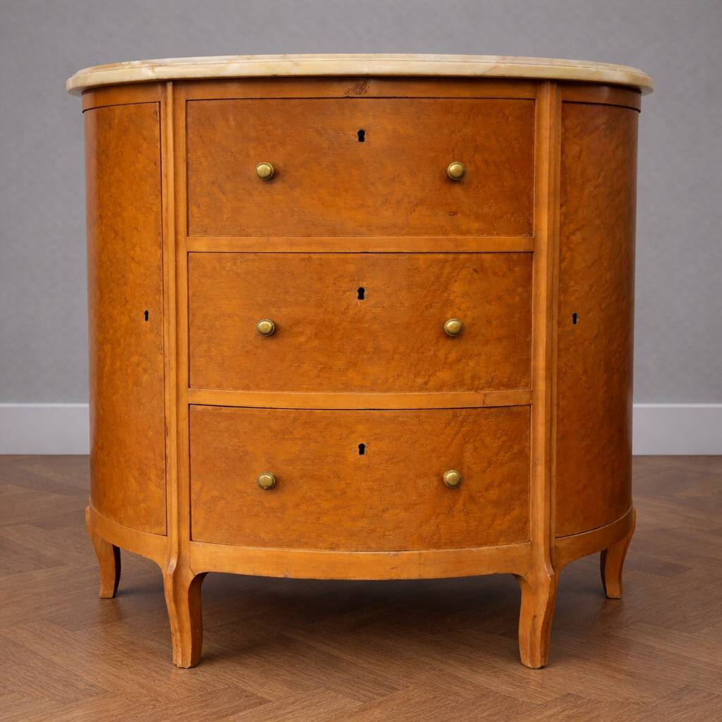 Half-moon commode in burl wood with a marble top.