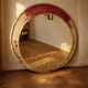 Vintage round mirror with an industrial metal frame in a painted finish.