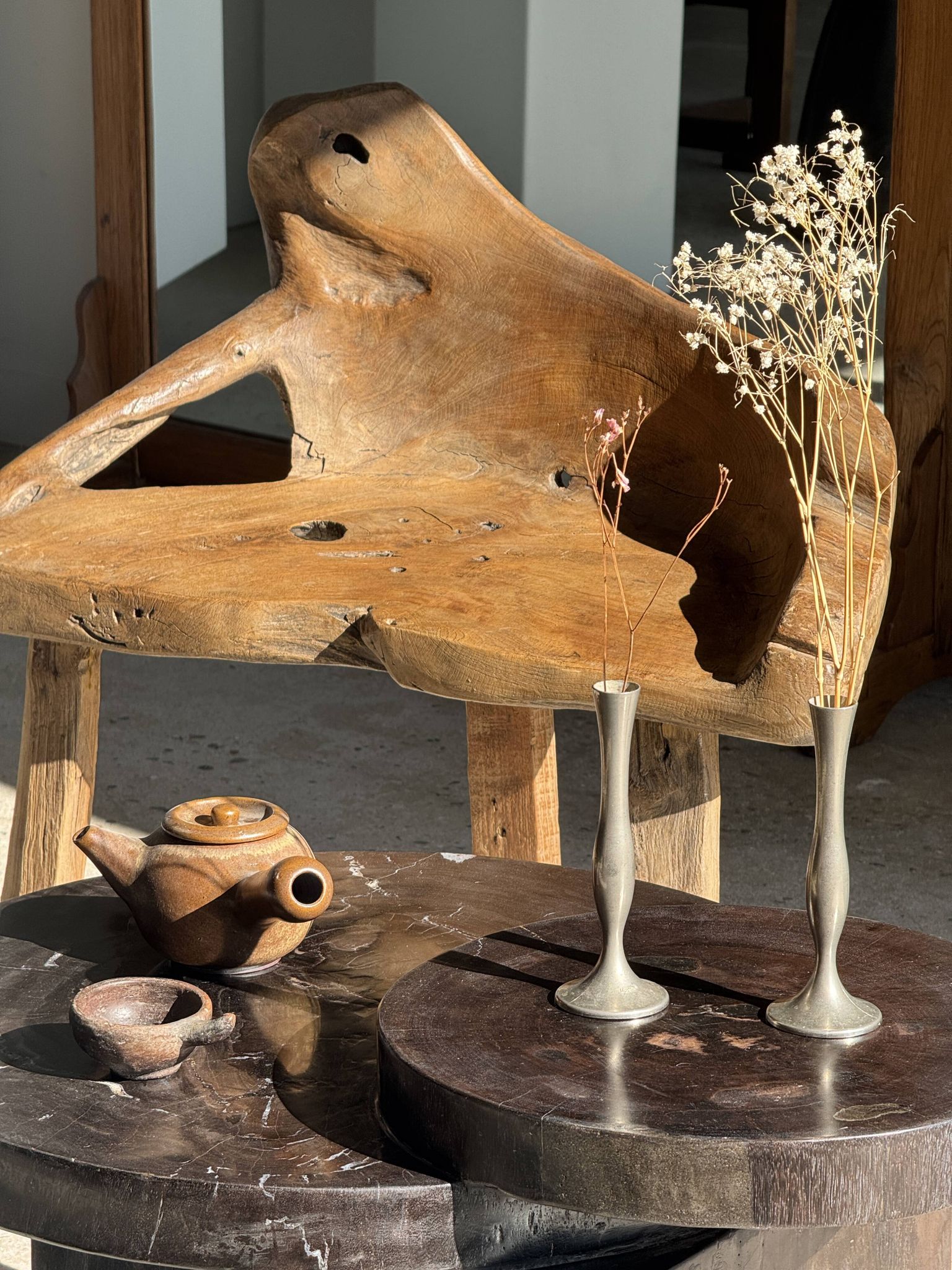 Brown petrified wood coffee table from Indonesia with a double circular top.