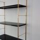 Modular string wall shelf in golden brass and black metal, 50s/60s