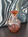 Vintage glass carafe in pink-orange, retro-chic style.