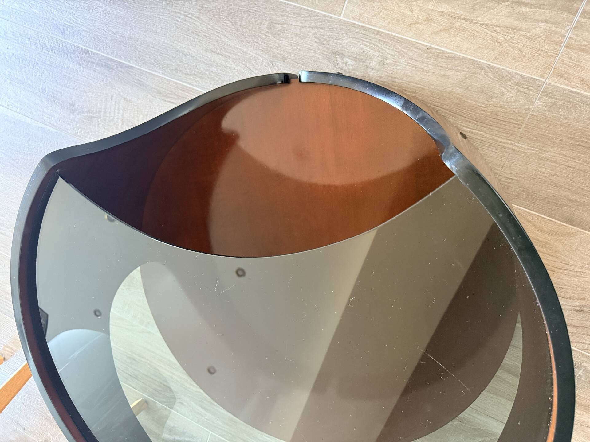 Italian Space Age coffee table in curved wood and smoked glass – 1970s
