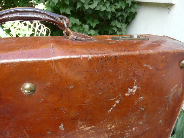 Old monogrammed leather travel suitcase and barony crown