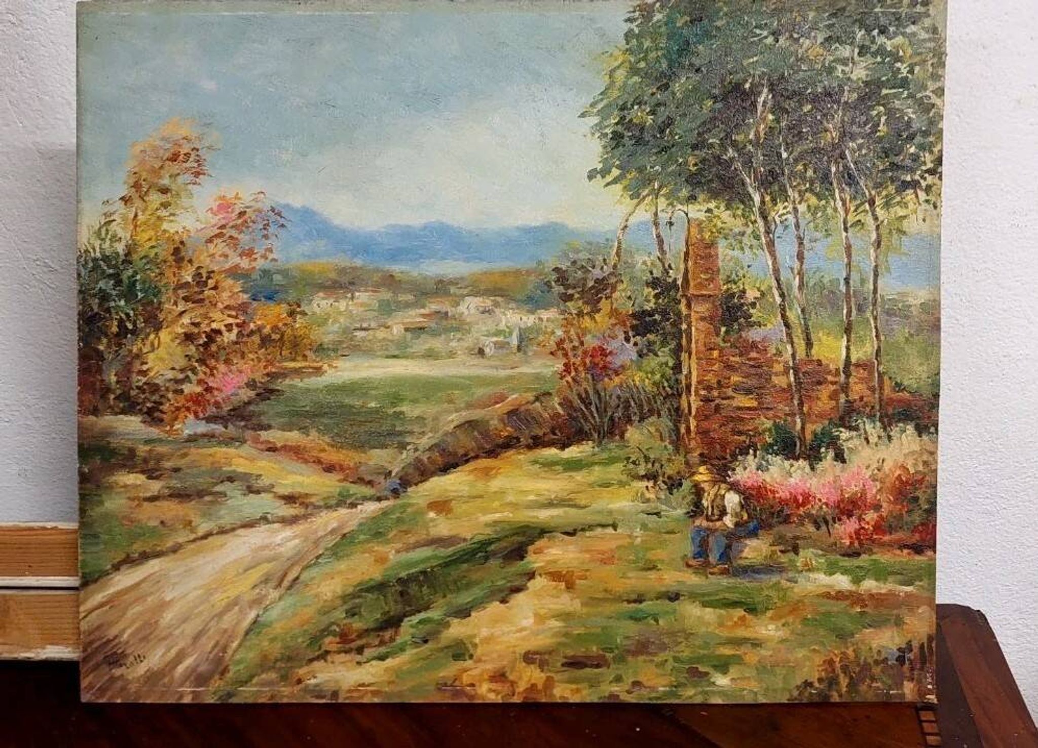 Oil painting on panel of a rural landscape, signed.