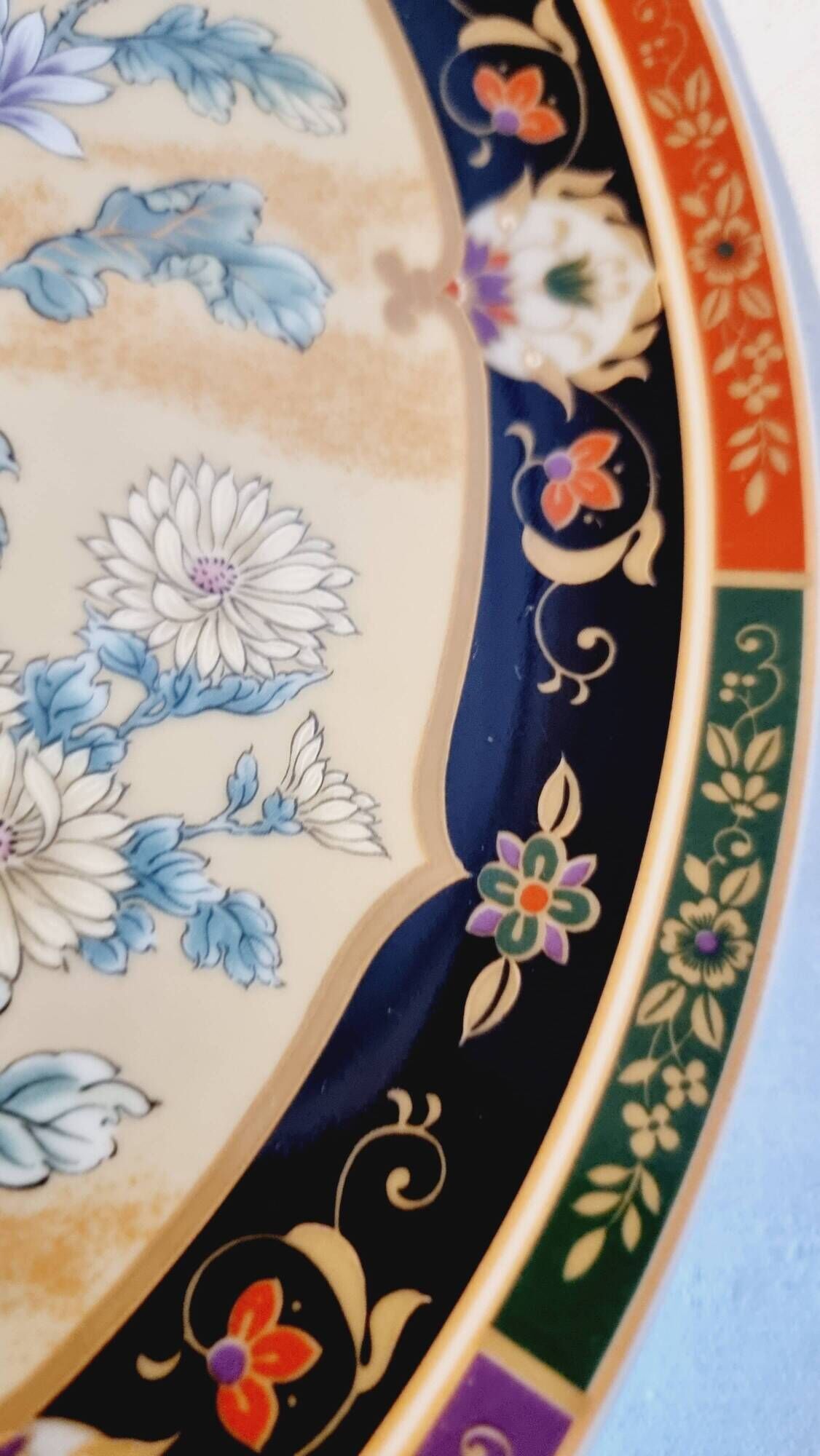 Vintage Japanese decorative plate with chrysanthemum and bird patterns.