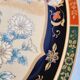 Vintage Japanese decorative plate with chrysanthemum and bird patterns.