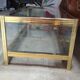 Vintage display coffee table in gilded brass and glass with a lock.
