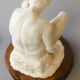 Sculpture of a seated man. Classical male sculpture. Male figure.