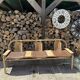 Baumann bench with wooden frame and faux leather seat.