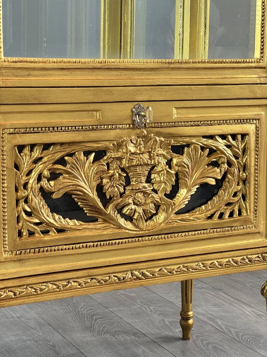 Carved and gilded wooden display cabinet, Louis XVI style, 20th century.