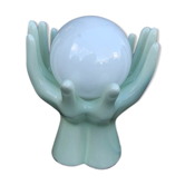Pale green globe and hands ceramic lamp