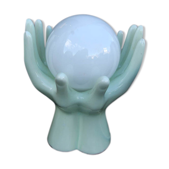 Pale green globe and hands ceramic lamp