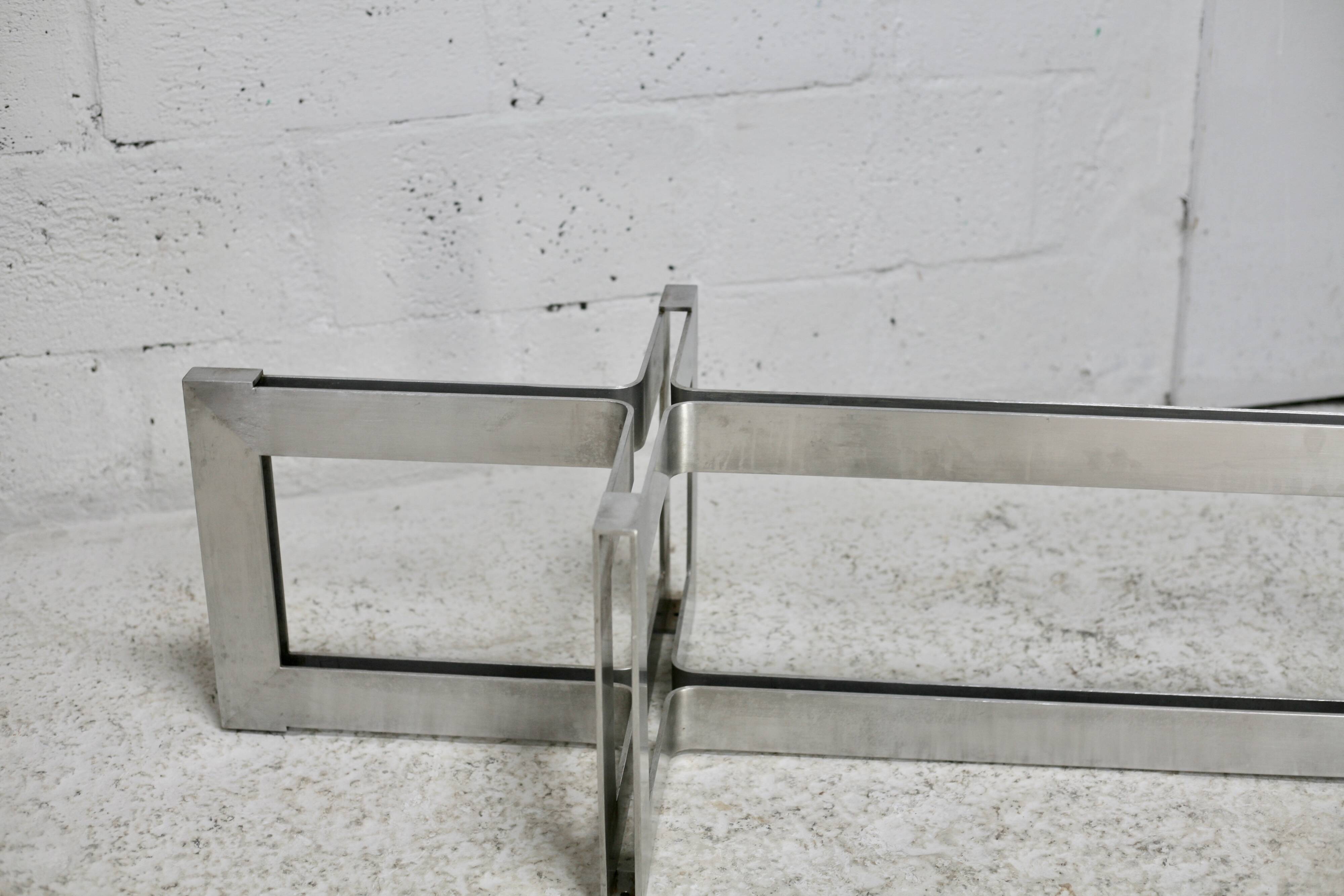 Coffee table with steel base and smoked glass slab. Circa 197