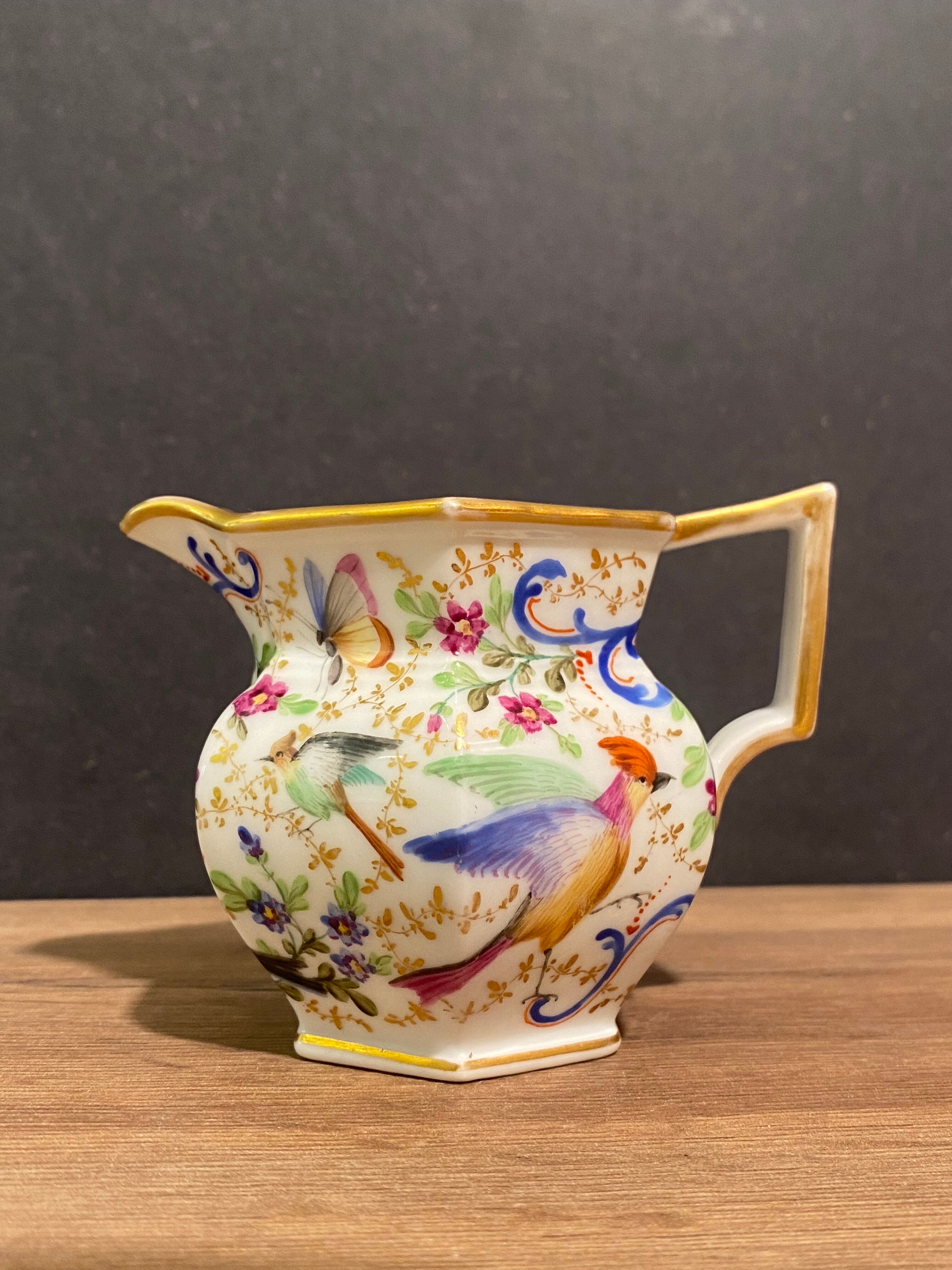 Old Paris porcelain milk jug with polychrome and gold bird floral decoration