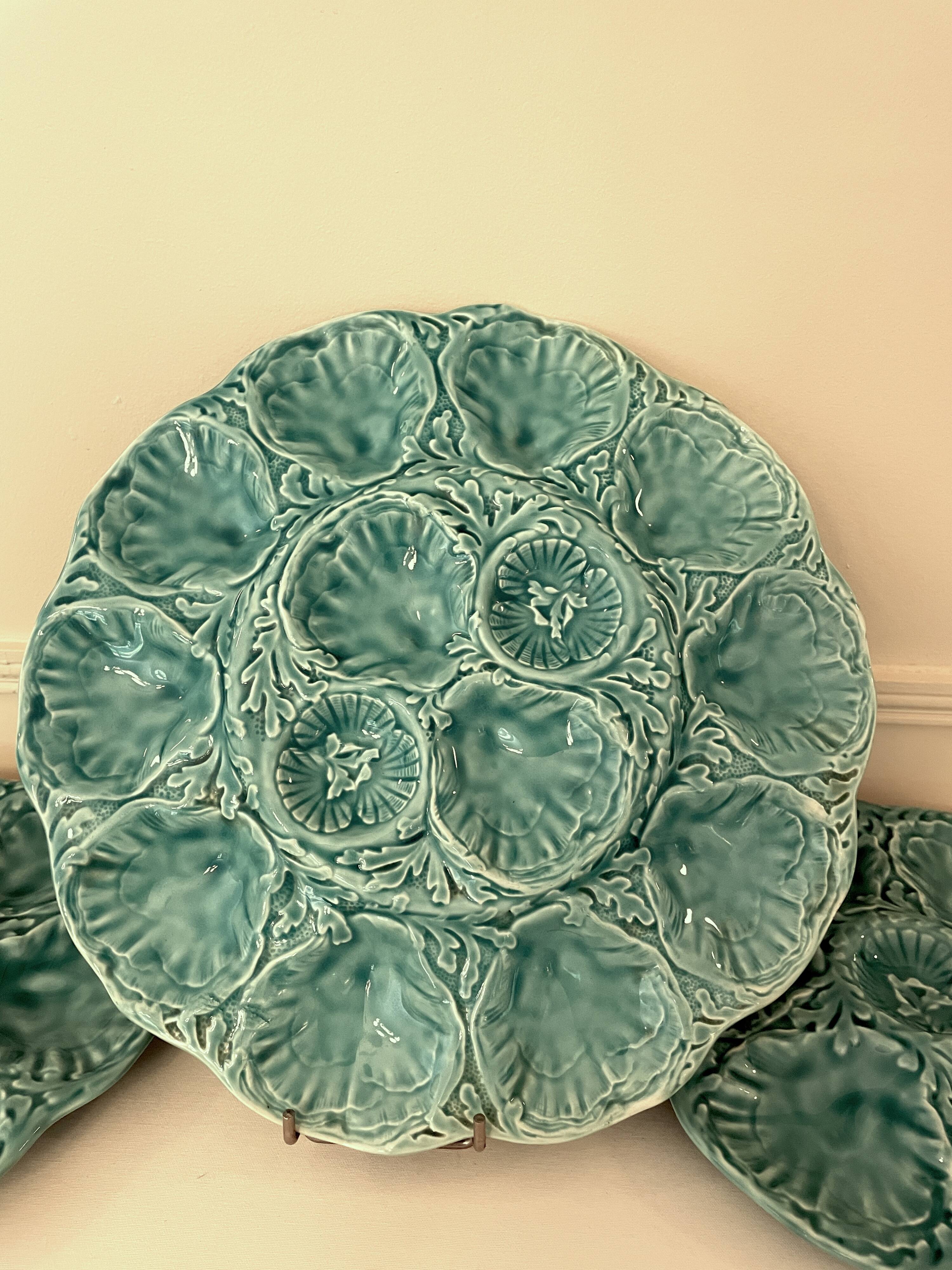 Dish and 4 turquoise faience oyster plates from Gien, France.