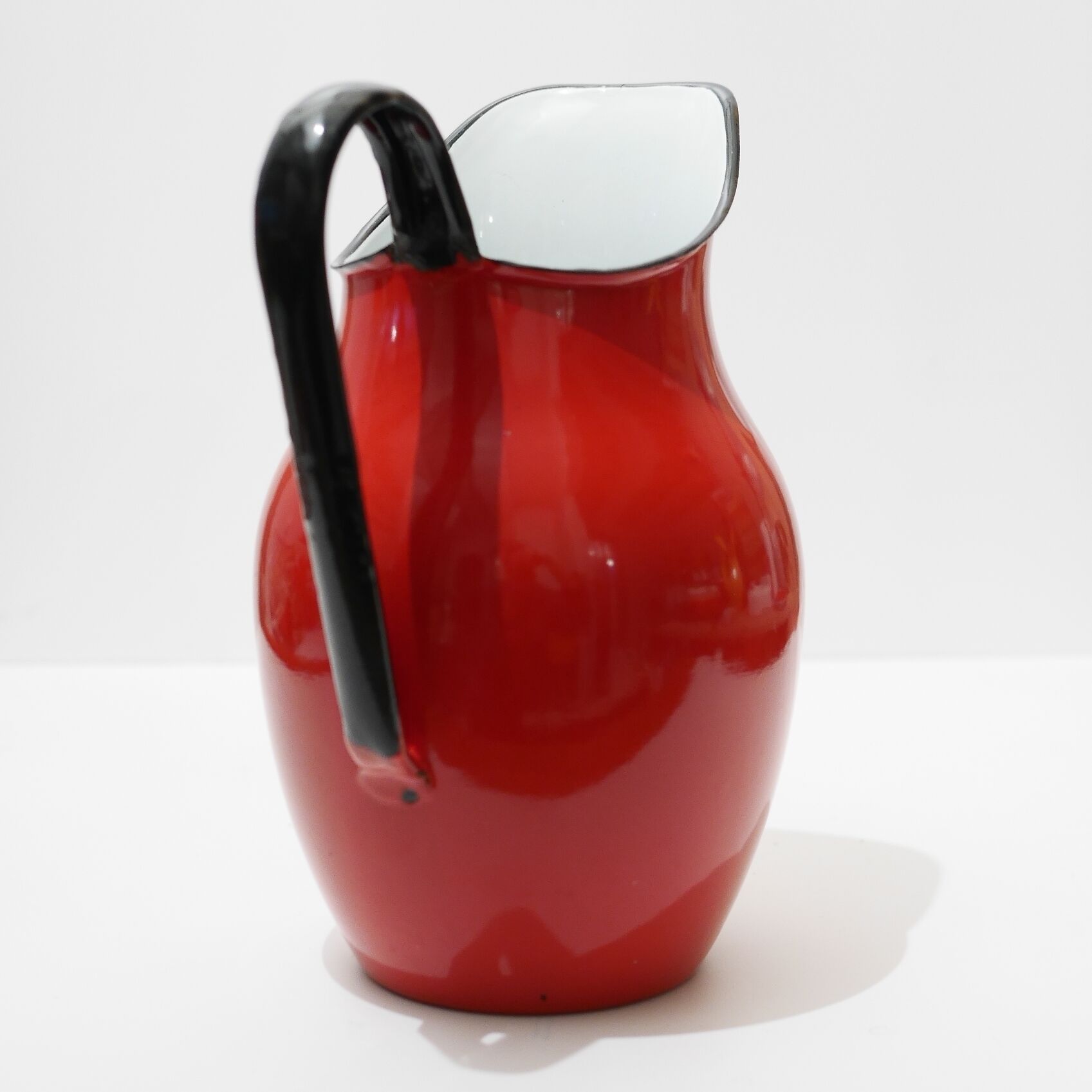 Red enameled metal pitcher