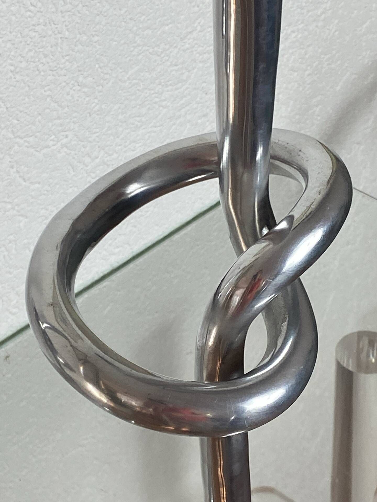 Pair of large aluminium bow candlesticks, Italy, 1970.
